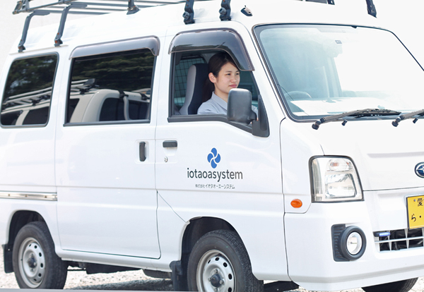 車で現場に向かう女性社員